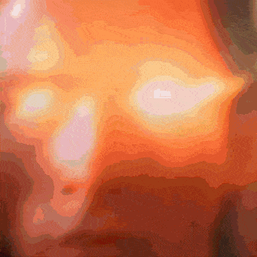 a close up of a red and orange background with a few white spots
