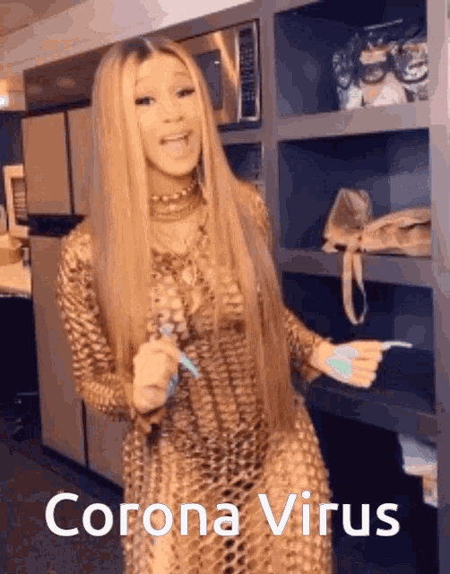 a woman in a gold dress is standing in a kitchen holding a toothbrush and a toothpaste .