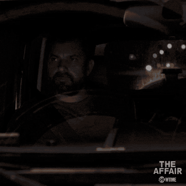 a man is driving a car in the dark with showtime written on the bottom right