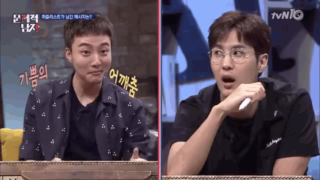 two men are sitting next to each other on a tv show and one has glasses on