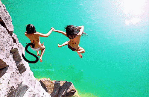 two women in bikinis jumping into a body of water with the letter s on the bottom