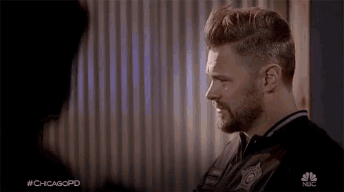 a man with a beard is talking to another man with #chicagopd on the bottom