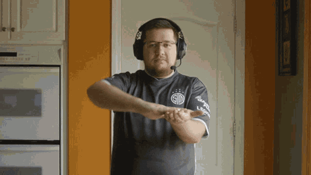 a man wearing headphones and a shirt that says sd on it