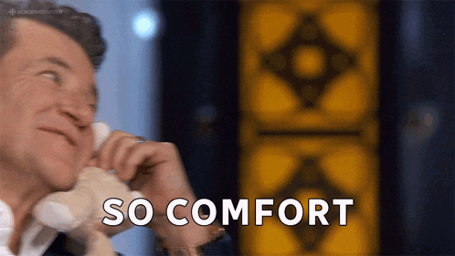 a man is holding a stuffed animal in his hand and says so comfort