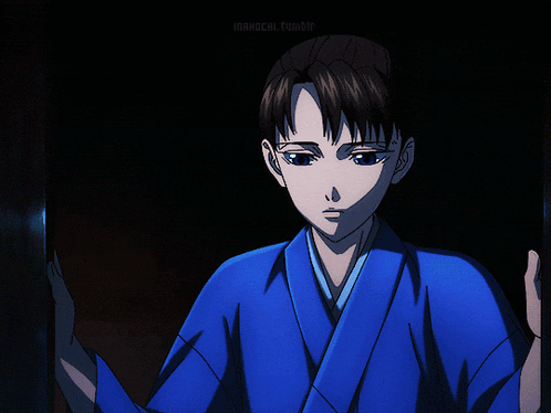 a boy in a blue kimono stands in the dark