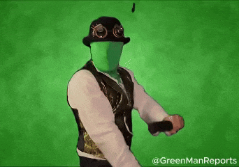 a man with a green face is wearing a hat and a vest .