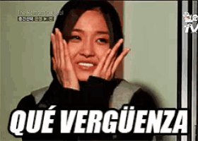 a woman is smiling with her hands on her face and the words que verguenza are above her