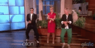 a group of people are dancing in front of a screen that says ellen