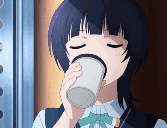 a girl with black hair drinking from a white cup