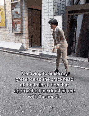 a man in a suit walking down a street with a sign that says antidote