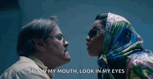 a man and woman are kissing with the words spit in my mouth look in my eyes above them