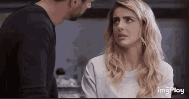 a man and a woman are looking at each other with the words imgplay in the corner