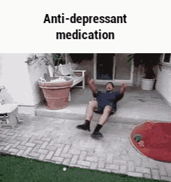 a man is sitting on the ground with his arms in the air and the words `` anti-depressant medication '' above him .