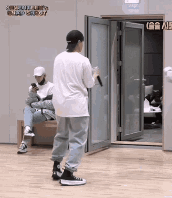 a man standing in front of a door with seventeen 's snap shot written on it