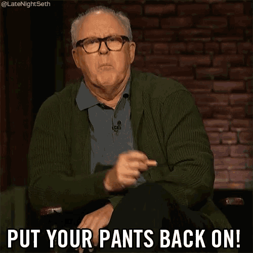an older man wearing glasses and a green sweater is sitting in front of a brick wall and says put your pants back on