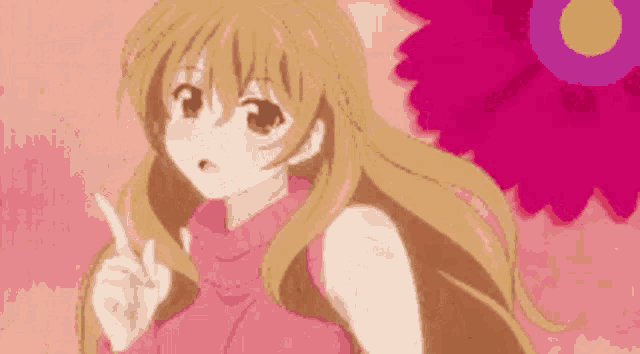 a girl in a pink sweater is pointing at something
