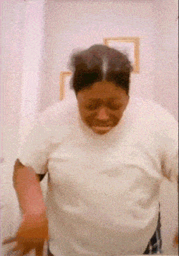 a woman in a white shirt is standing in a bathroom