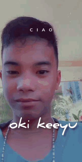 a young man with the name oki keeyu written on his neck