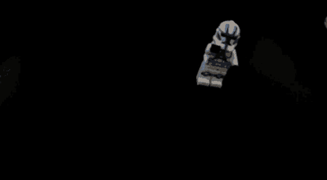 a white lego figure with a blue u on his head