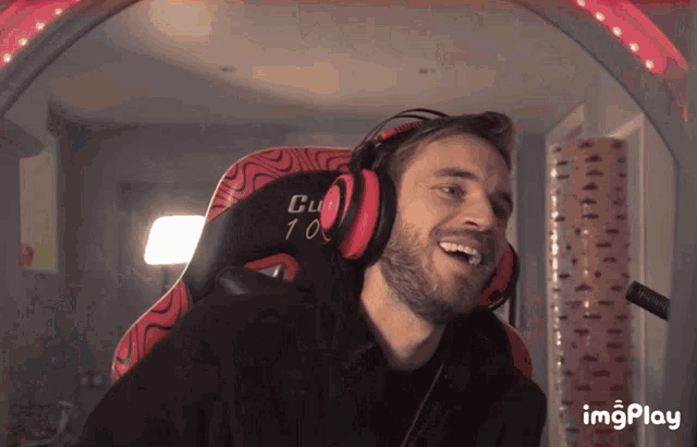 a man wearing headphones is sitting in a chair that says club 10