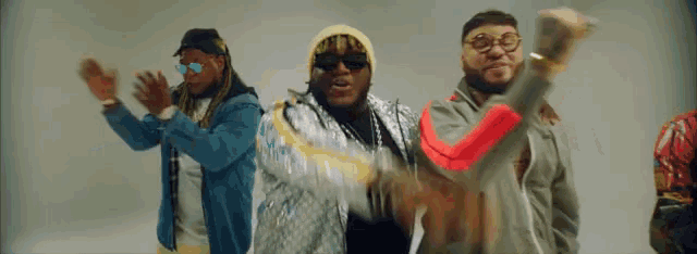 a group of men are dancing together and one of them is wearing a gucci jacket