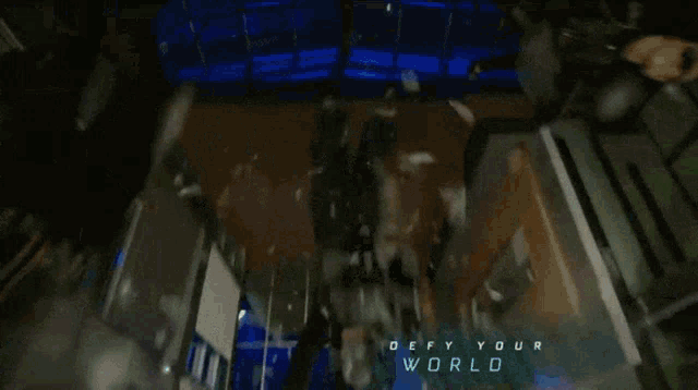 a building with the words " defy your world " on the bottom