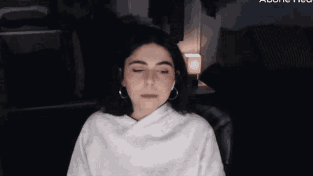 a woman with her eyes closed in front of a screen that says " adobe "