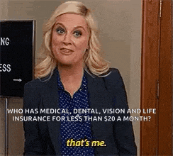 a woman in a suit is standing in front of a door and talking about insurance .