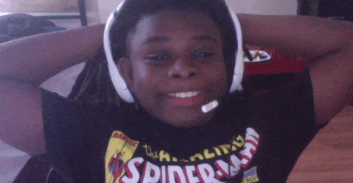 a boy wearing headphones and a spiderman shirt