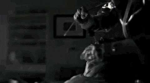 a close up of a person 's face in a dark room with a lot of smoke coming out of it .