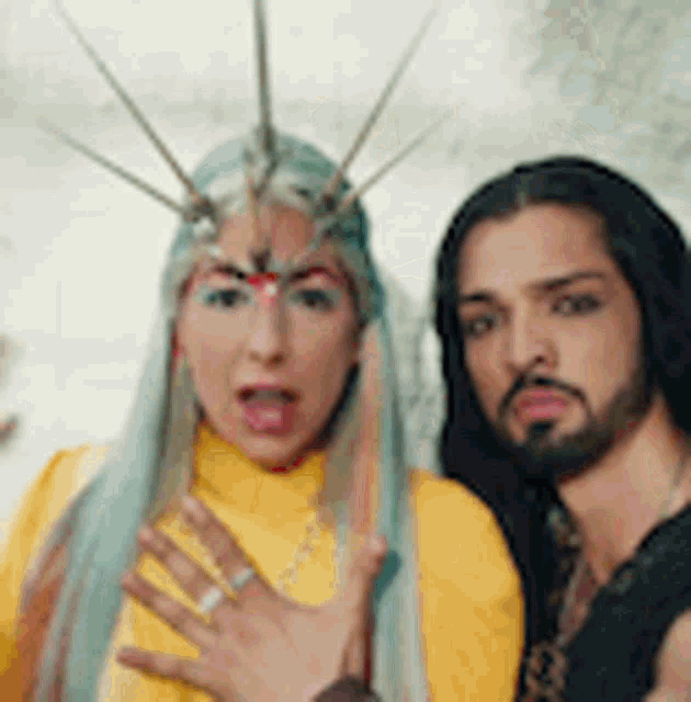 a man and a woman are posing for a picture together .