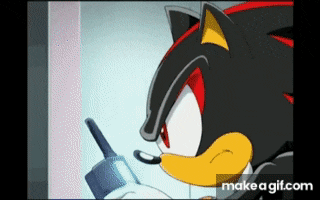 shadow the hedgehog from sonic the hedgehog is talking on a walkie talkie .