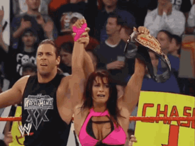 a man and a woman are holding a wrestling championship while holding a sign that says chase