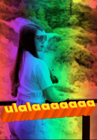 a woman is standing in front of a waterfall with a rainbow background and the words " ulalalaaaa " on the bottom right