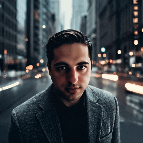 a man in a suit is standing in front of a city street