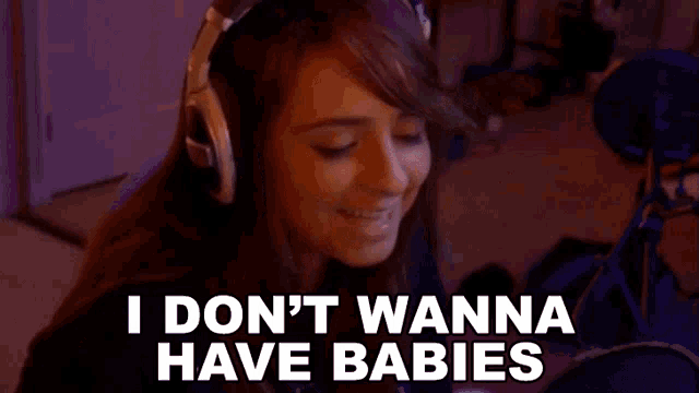 a woman wearing headphones is talking into a microphone and says `` i don 't wanna have babies ''