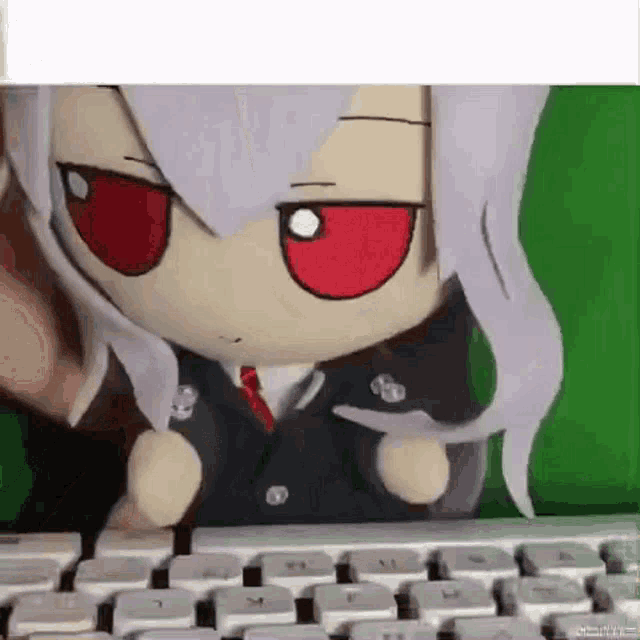 a stuffed toy is sitting on top of a keyboard .