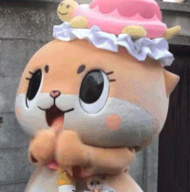 a mascot is wearing a pink hat with a turtle on it 's head .