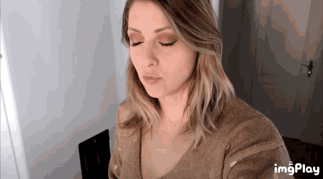 a close up of a woman 's face with the words imgplay visible