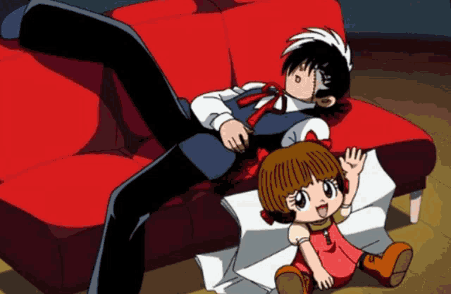 a man laying on a red couch next to a girl
