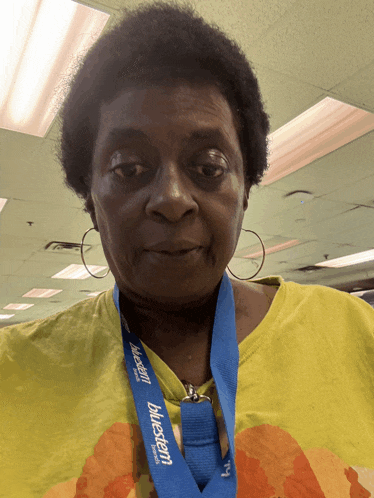 a woman with a blue lanyard around her neck that says bluestem
