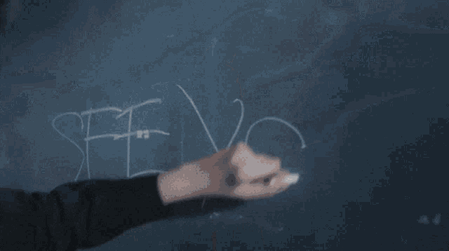 a girl is standing in front of a blackboard that says " girl from nowhere " on it