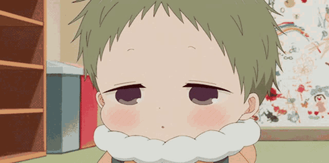 a baby with green hair and a white scarf around his neck is looking at the camera