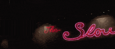a neon sign for the low club with a deer head on it