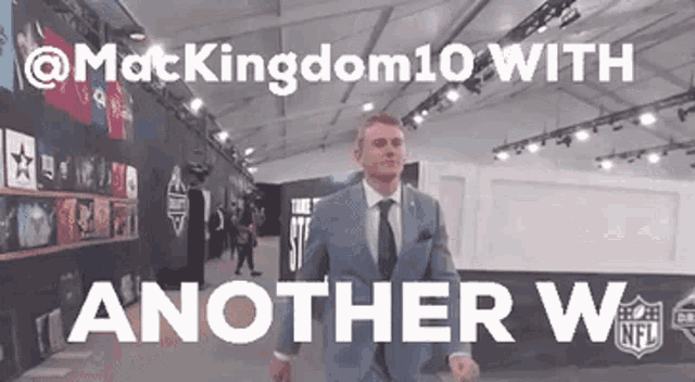 a man in a suit and tie is walking in a room with the words " another way " written on it
