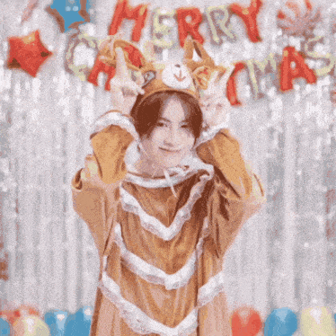 a man in a reindeer costume is giving a peace sign