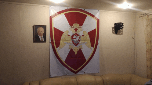 a picture of a man hanging on a wall next to a shield