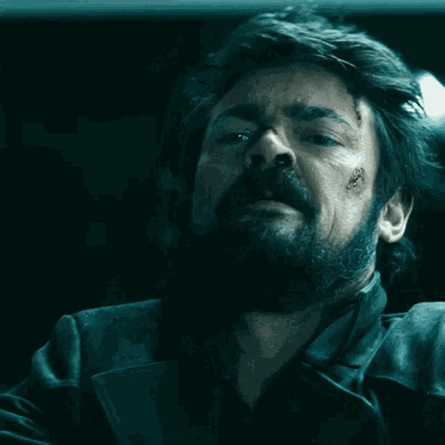 a man with a beard has a bloody nose