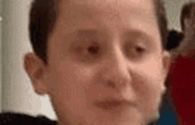 a close up of a person 's face with a blurred background .
