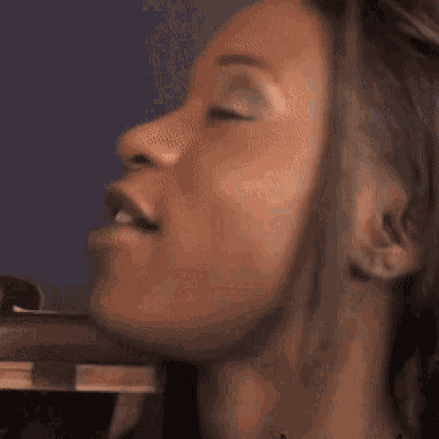 a close up of a woman 's face making a funny face .